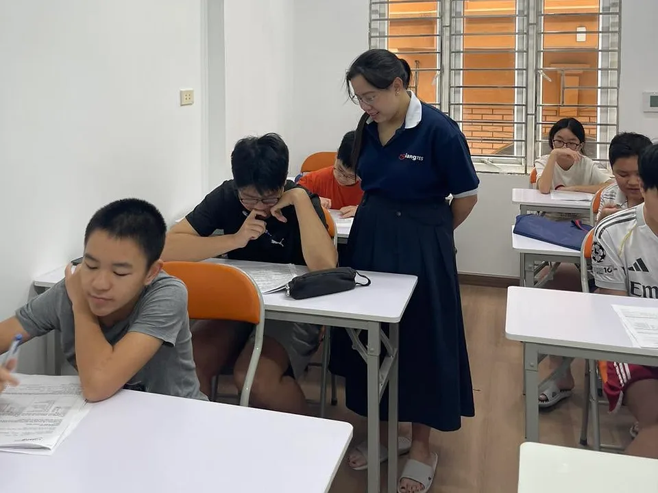 Giáo viên theo dõi học sinh làm bài đánh giá trong lớp